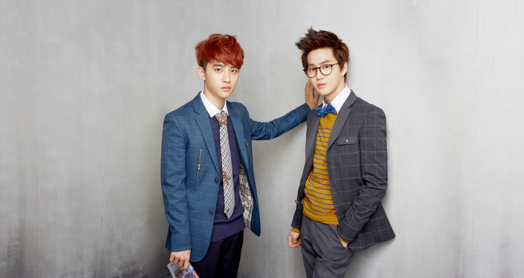 HD PC desktop wallpaper featuring two EXO members dressed in stylish suits against a neutral gray background, highlighting music and modern fashion.