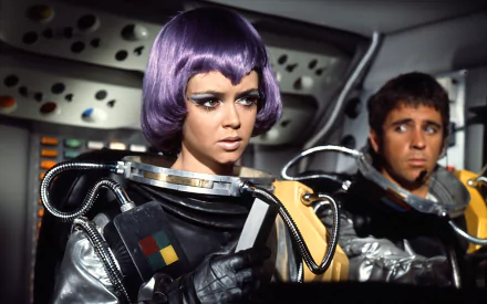 HD PC desktop wallpaper featuring characters from the 1970 TV show UFO, showcasing futuristic space suits and intense expressions inside a spacecraft cockpit.