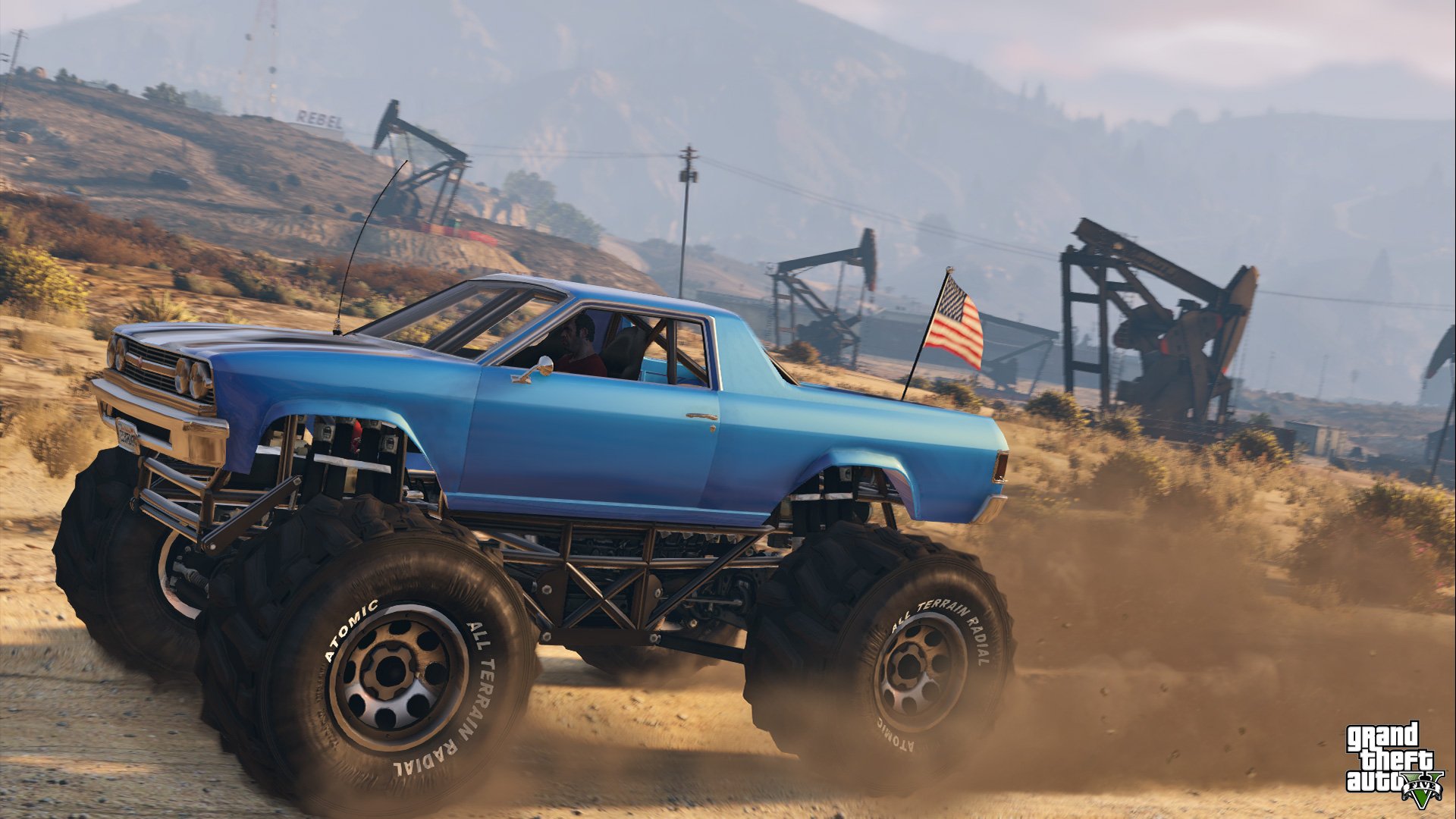 HD wallpaper featuring a monster truck from Grand Theft Auto V, kicking up dust in a desert landscape with oil pumps in the background.