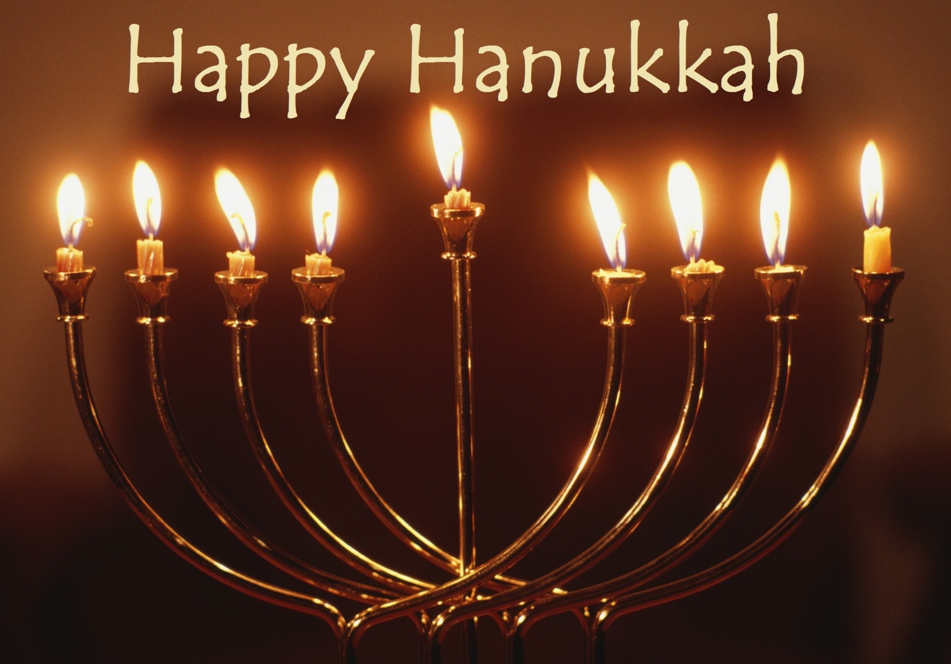 HD PC desktop wallpaper featuring a glowing Hanukkah menorah with lit candles and the text Happy Hanukkah celebrating the holiday.