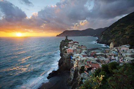 Sunset over the sea and colorful coastal village of Manarola in Cinque Terre, Italy, captured in vibrant HD for a stunning desktop wallpaper.