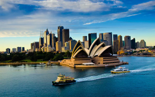 4K Ultra HD image of Sydney Opera House and the city skyline in Australia, showcasing iconic man-made architecture against a vibrant sky and harbor setting.