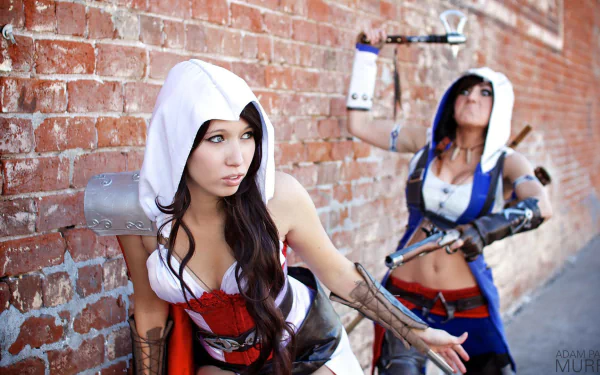 HD desktop wallpaper featuring a cosplay of Jessica Nigri, showing two women in detailed costumes against a brick wall background.
