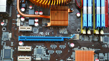 Close-up of a motherboard featuring intricate circuitry and components, showcasing modern computer technology. This HD image serves as a dynamic desktop wallpaper.