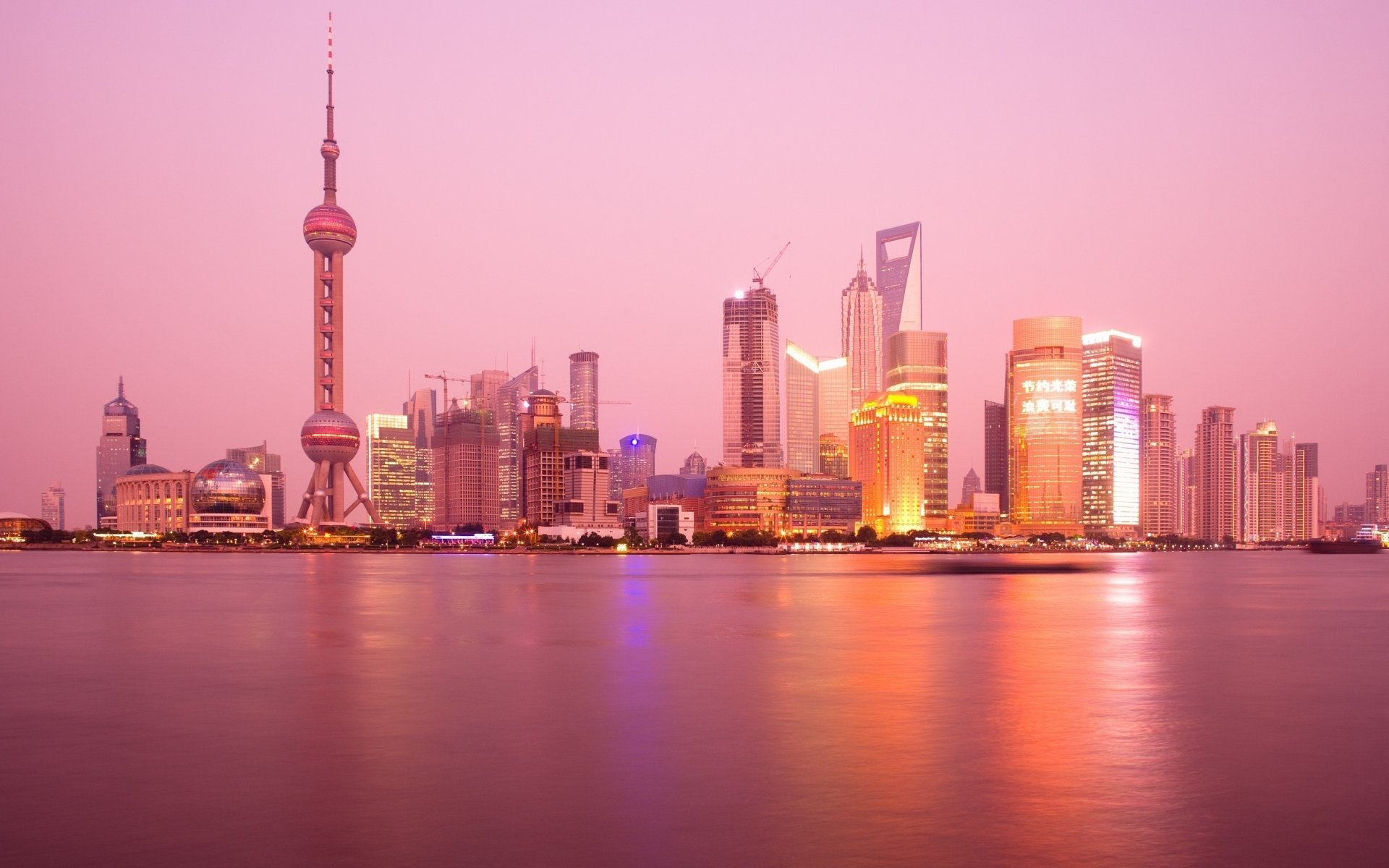 4K Ultra HD image of Shanghai's skyline at dusk, featuring the iconic man-made Oriental Pearl Tower against a pink sky.