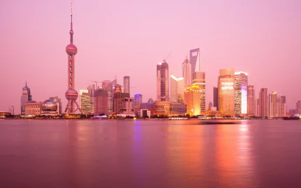 4K Ultra HD image of Shanghai's skyline at dusk, featuring the iconic man-made Oriental Pearl Tower against a pink sky.