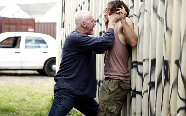 HD PC desktop wallpaper from the movie The Art Of The Steal showing a tense confrontation between two men, one pressing the other against a graffiti-covered wall.