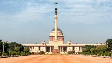 HD desktop wallpaper of the man-made Rashtrapati Bhavan, showcasing its grand architecture under a partly cloudy sky.