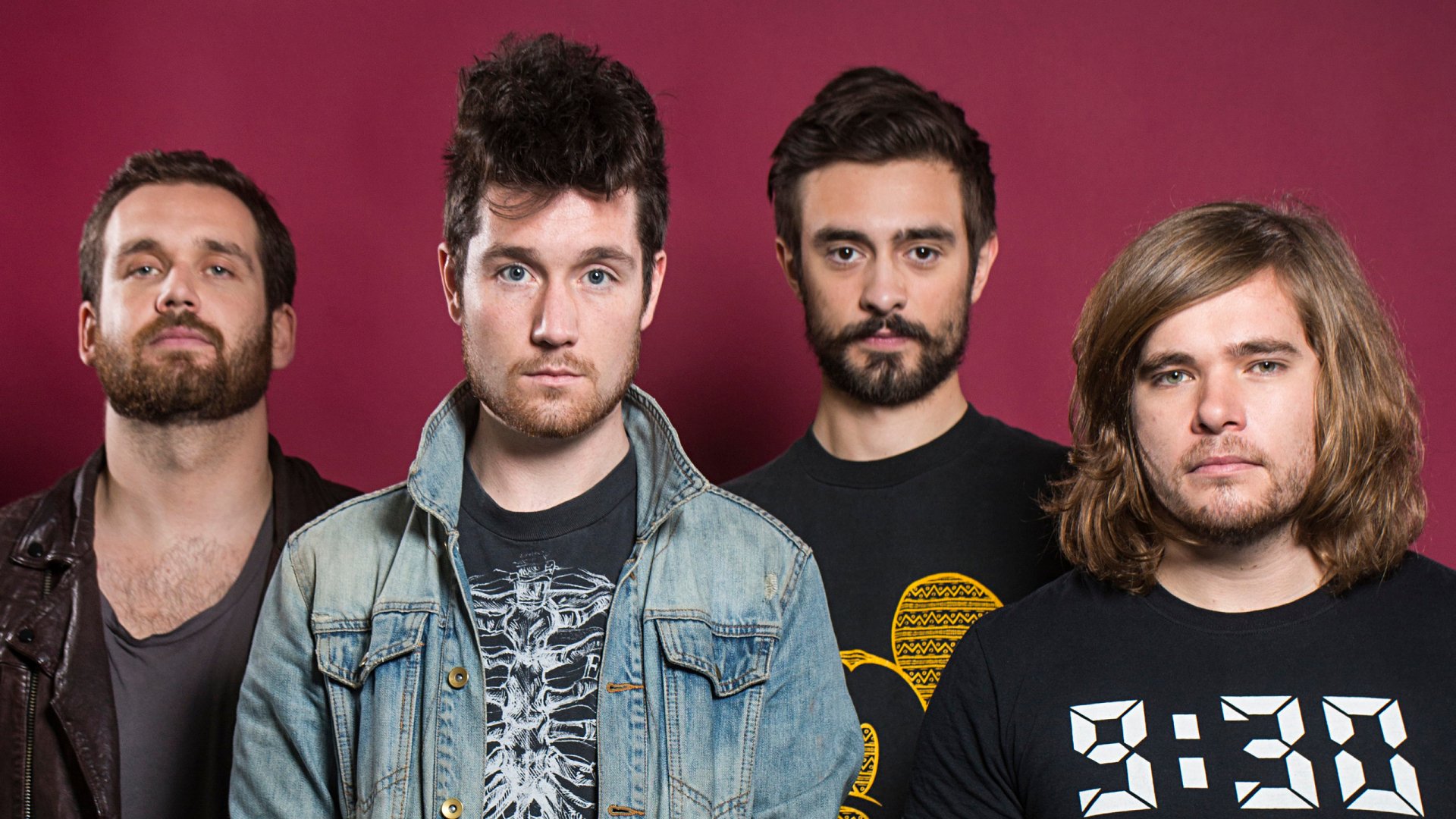 HD desktop wallpaper featuring the English rock band Bastille posing against a solid red background.