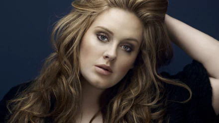 Adele, the renowned British singer, gazes thoughtfully in this high-definition desktop wallpaper, capturing her striking beauty and powerful presence in the music world.