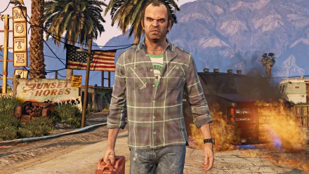 HD wallpaper of Trevor Philips from Grand Theft Auto V, walking with a gas can in hand, with an American flag and a burning vehicle in the background.