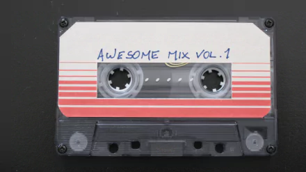 HD PC desktop wallpaper of a cassette tape labeled Awesome Mix Vol. 1 from the movie Guardians of the Galaxy.