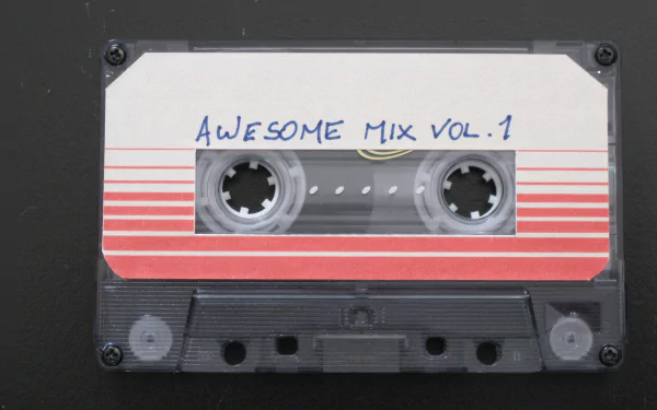 HD PC desktop wallpaper of a cassette tape labeled Awesome Mix Vol. 1 from the movie Guardians of the Galaxy.