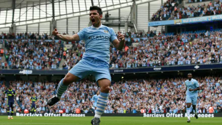 Sergio Agüero celebrates a goal for Manchester City F.C. in a vibrant stadium filled with cheering fans, capturing the spirit of iconic sports moments in this HD wallpaper.
