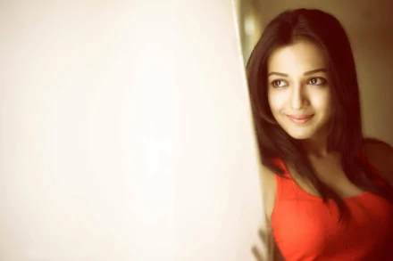 HD Bollywood desktop wallpaper featuring actress Catherine Tresa smiling softly, captured with warm lighting and a blurred background.
