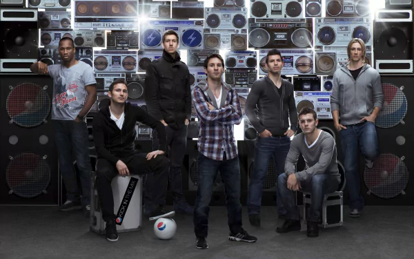 A dynamic HD wallpaper featuring soccer stars Fernando Torres, Jack Wilshere, Sergio Agüero, Lionel Messi, Frank Lampard, and Didier Drogba posed against a vibrant backdrop of vintage speakers.