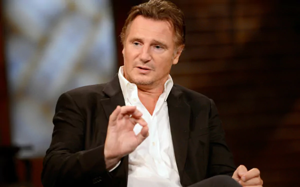 HD wallpaper featuring a man in a black suit speaking, a perfect background for those who appreciate thought-provoking discussions.