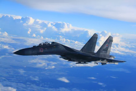 A Sukhoi Su-35 fighter jet soars above the clouds, showcasing its sleek design and military prowess. This HD wallpaper captures the essence of modern air force capabilities.
