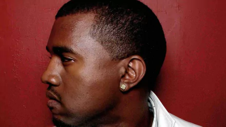 A striking HD wallpaper featuring Kanye West, showcasing his profile against a bold red background, capturing the essence of his presence in the music scene.