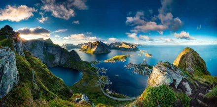 HD wallpaper of Reine village on the Lofoten Islands, Norway. The landscape features a picturesque coastline, serene ocean, winding fjords, and lush greenery under a vibrant sky with scattered clouds.