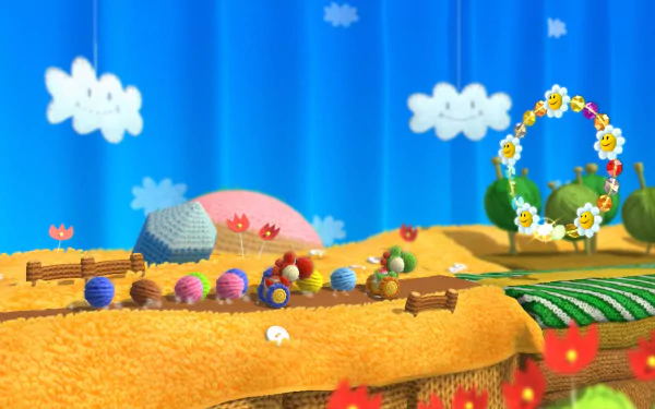 HD desktop wallpaper from Yoshi's Woolly World showcasing a vibrant, yarn-themed landscape with colorful decorations and a blue sky backdrop.