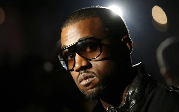 HD wallpaper of a man in glasses with a thoughtful expression, suitable as a computer desktop background.