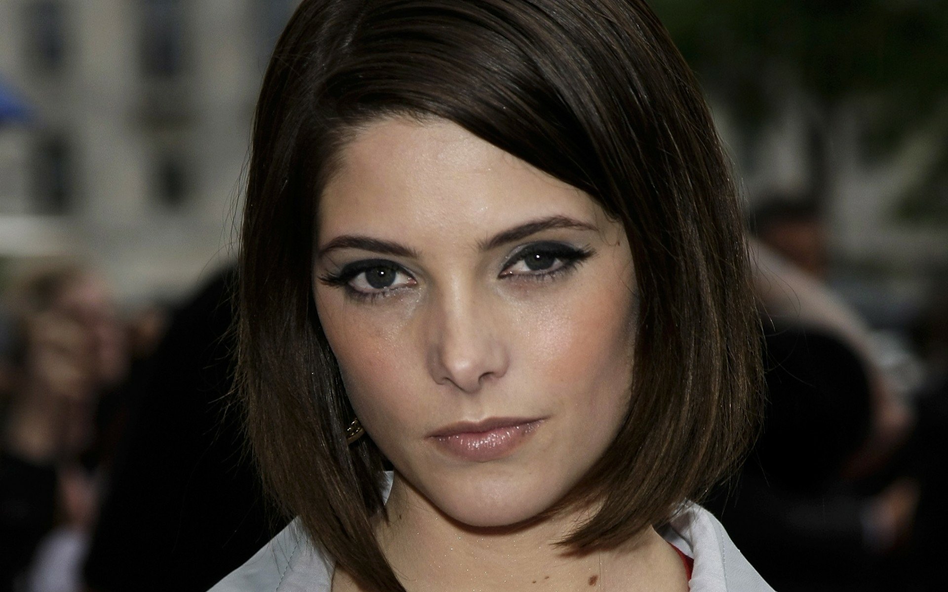 Close-up portrait of a female celebrity with chin-length dark bob, smoky eye makeup and neutral expression; HD PC desktop wallpaper/background.