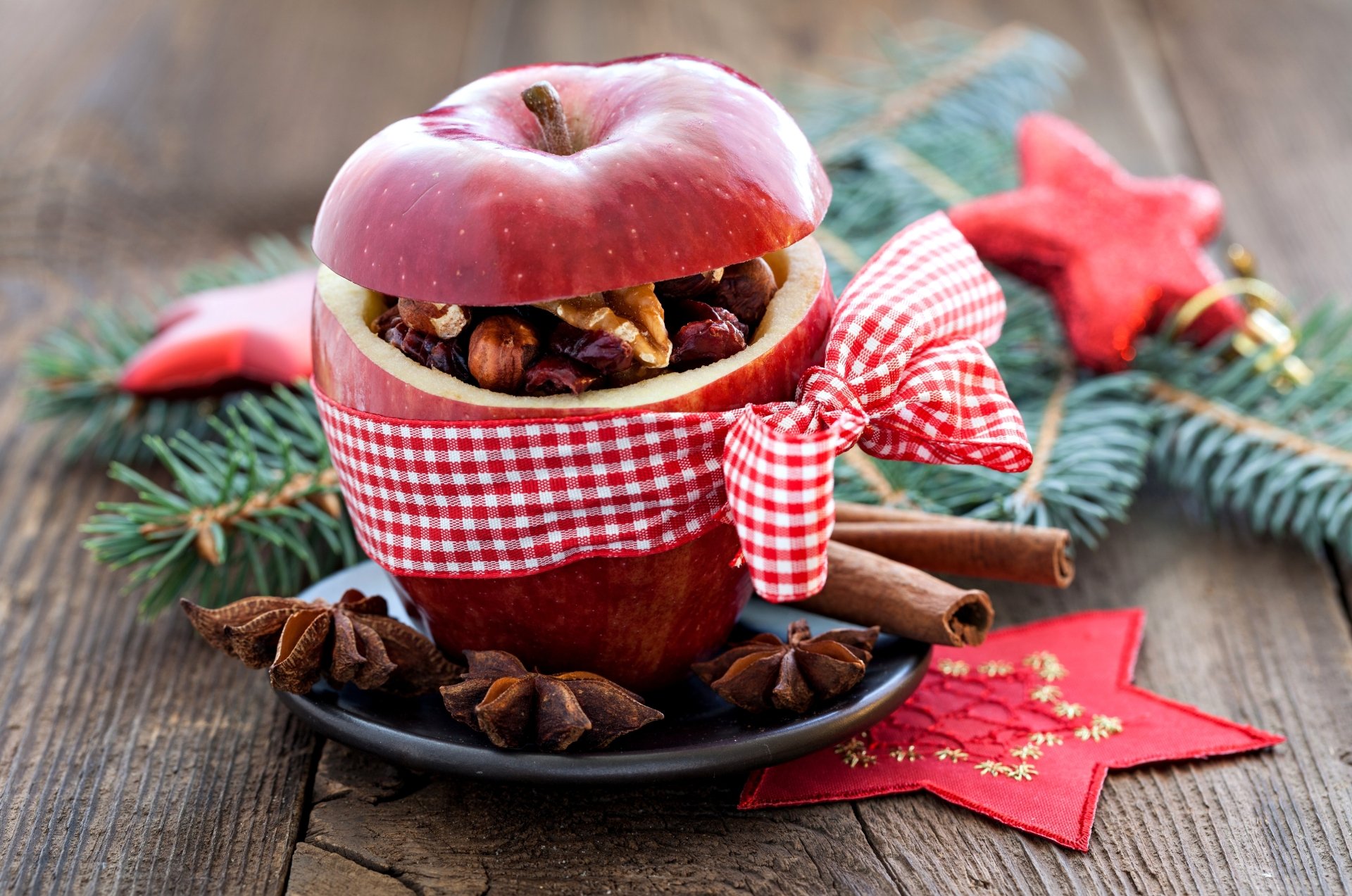 A festive holiday scene featuring a red apple filled with nuts and spices, wrapped with a checkered ribbon, set against Christmas decorations in 8K Ultra HD.