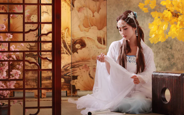 A Taiwanese woman in traditional mikao costume sits gracefully, holding fabric, surrounded by beautiful decor, evoking cultural heritage and elegance in a serene setting.