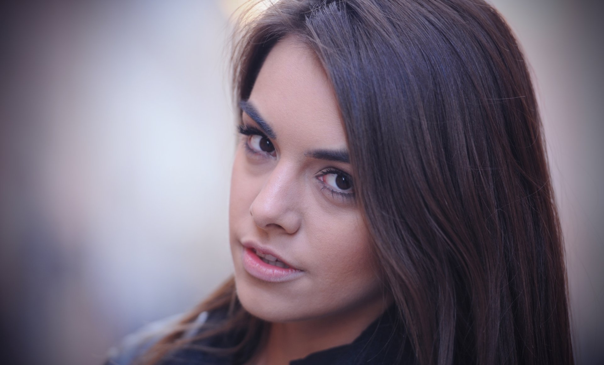 Close-up portrait of a woman with long dark hair and expressive eyes by Anita Sikorska, rendered in 4K Ultra HD for PC desktop wallpaper and background.