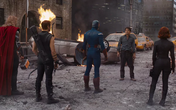 HD PC desktop wallpaper of Avengers — Thor, Hawkeye, Captain America, Bruce Banner and Black Widow standing in a ruined city street with overturned cars and burning wreckage.