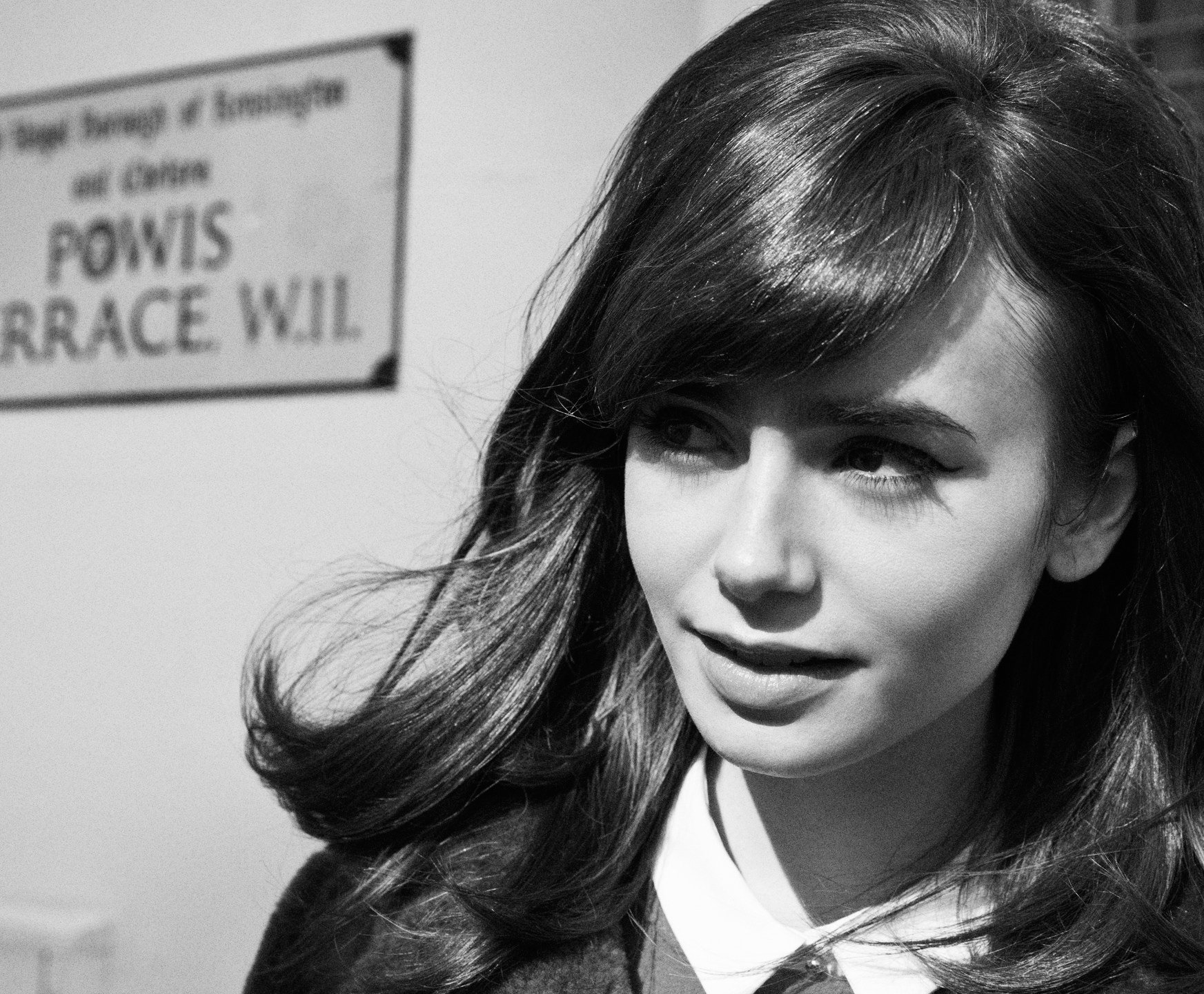 Black-and-white HD PC desktop wallpaper of a female celebrity in a close-up portrait, side-swept hair and a soft, thoughtful smile.