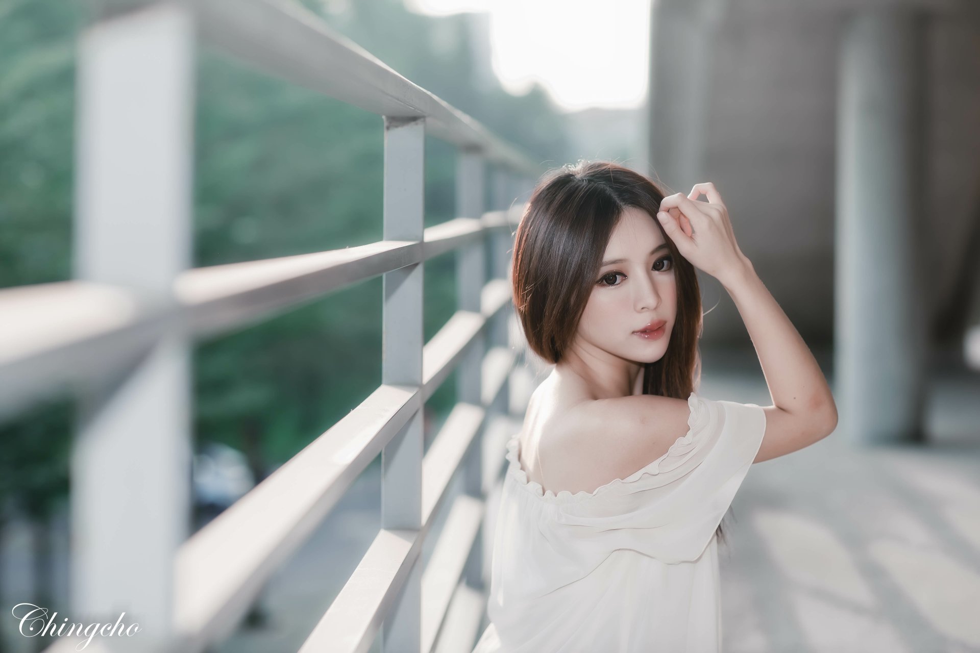 Portrait of a Taiwanese woman, Julie Chang, posing outdoors by a railing, captured in 4K Ultra HD as a PC desktop wallpaper and background.