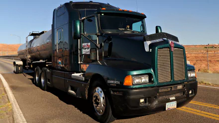 HD PC desktop wallpaper featuring a sleek dark green Kenworth truck hauling a tanker trailer on an open desert road under a clear blue sky.