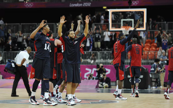 A group of basketball players celebrates during a game at the London 2012 Olympics, showcasing dynamic movement on the court. This vibrant image serves as a 4K Ultra HD desktop wallpaper and background.