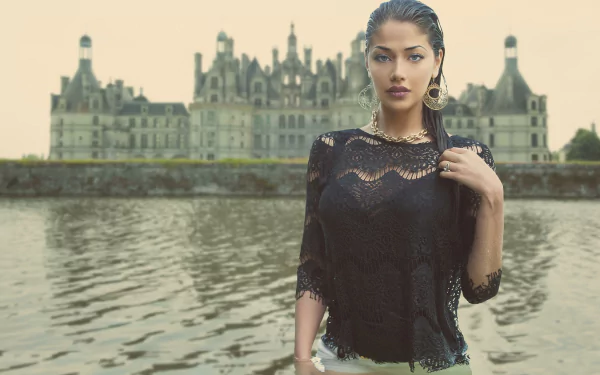A woman model poses confidently near the water with the Château de Chambord in France as the backdrop in this HD desktop wallpaper.