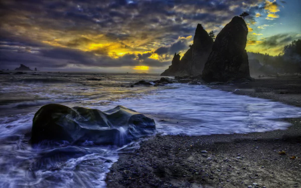 A dramatic seascape at sunset, featuring rugged cliffs, gentle waves lapping at the shore, and a colorful sky filled with clouds, capturing the essence of summer evenings by the coastline.