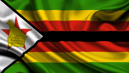 HD desktop wallpaper featuring the vibrant national flag of Zimbabwe with its distinct green, gold, red, black stripes, and the white triangle bearing the Zimbabwe Bird emblem.