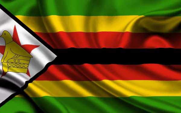 HD desktop wallpaper featuring the vibrant national flag of Zimbabwe with its distinct green, gold, red, black stripes, and the white triangle bearing the Zimbabwe Bird emblem.