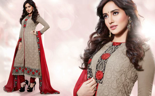 A stunning model showcases traditional Indian national dress, featuring intricate embroidery and vibrant colors, captured in high-definition for a striking wallpaper background.
