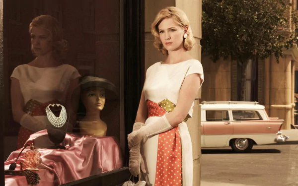 HD PC desktop wallpaper featuring celebrity January Jones in a vintage-style dress standing by a shop window with mannequins and a classic car in the background.