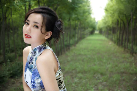A portrait of a Chinese woman, Hú Yǐng Yí, in a floral cheongsam, poses gracefully in a serene green pathway, captured in 4K Ultra HD quality.