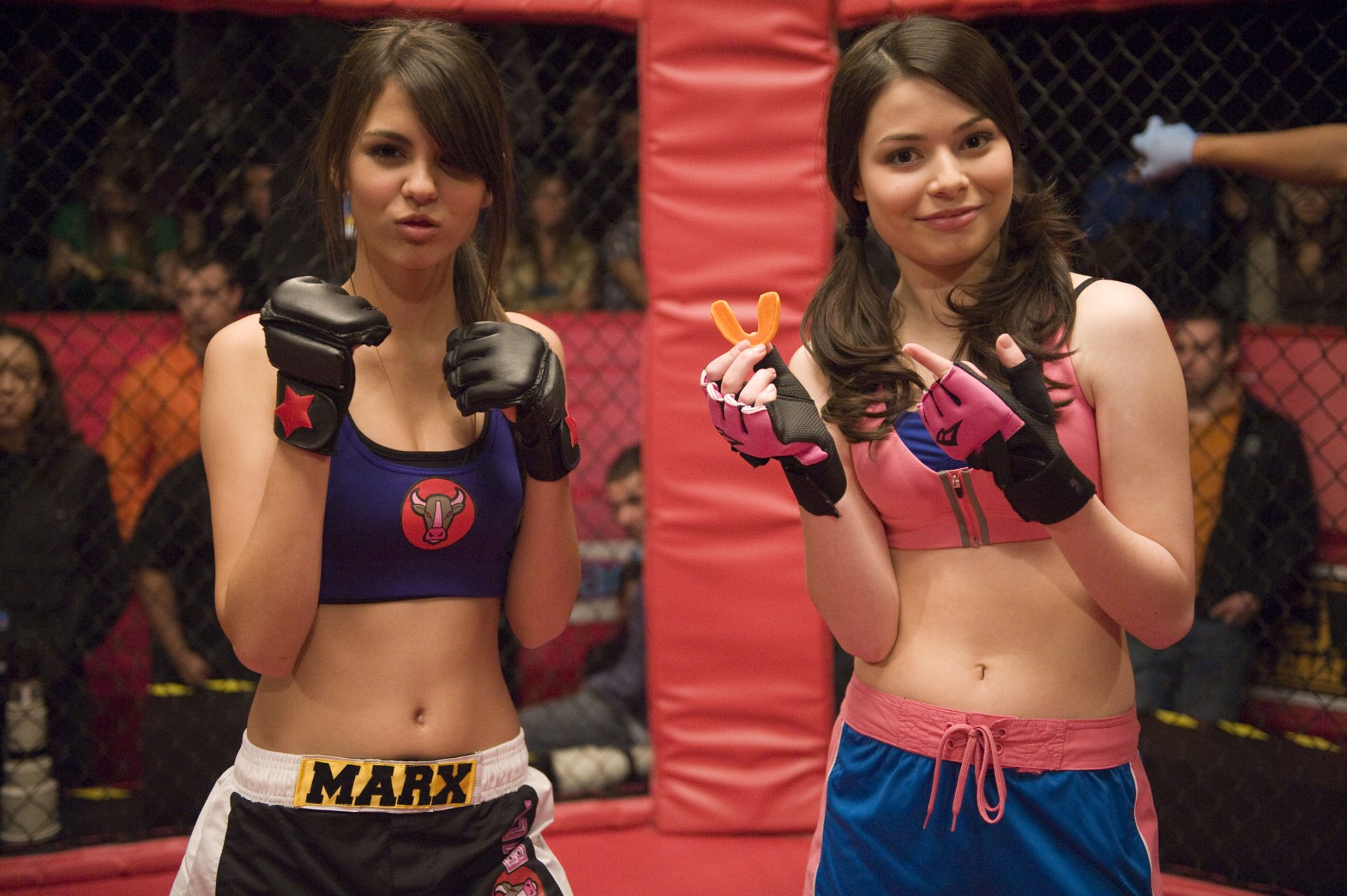 HD PC desktop wallpaper featuring two characters from the TV show iCarly (2007) dressed in boxing gear inside a cage fighting ring.