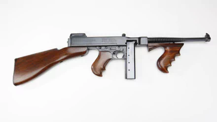 A high-definition desktop wallpaper featuring a detailed view of a machine gun with wooden accents, showcasing the craftsmanship of man-made weaponry.