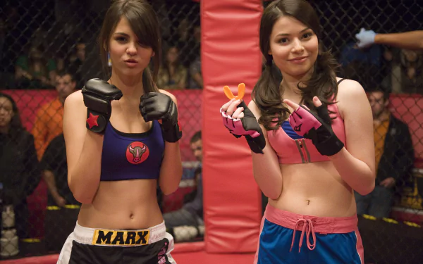 HD PC desktop wallpaper featuring two characters from the TV show iCarly (2007) dressed in boxing gear inside a cage fighting ring.