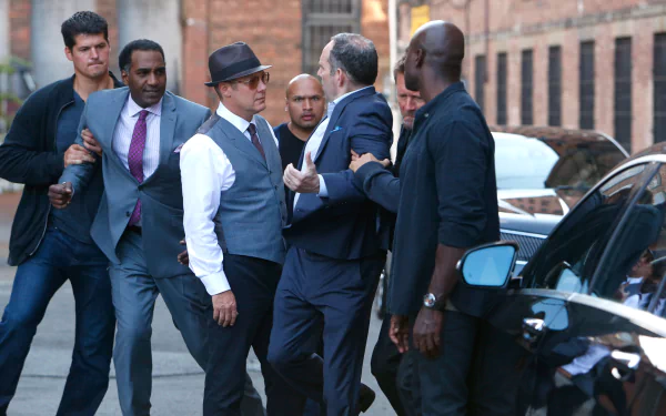 HD desktop wallpaper featuring characters from The Blacklist in an intense street scene, suitable as a background.