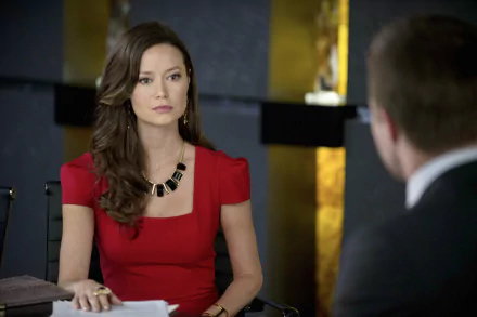 Isabel Rochev, portrayed by Summer Glau in the TV show Arrow, sits seriously at a table in this HD desktop wallpaper and background.