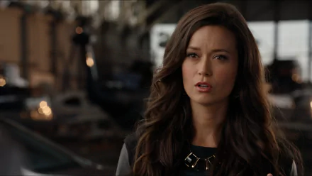 HD desktop wallpaper featuring Summer Glau as Isabel Rochev from the TV show Arrow, showcasing her serious expression in a dimly lit setting.