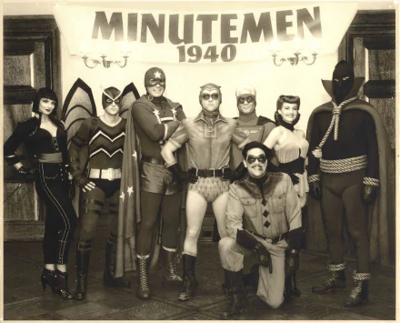 HD PC desktop wallpaper featuring the Watchmen movie cast in vintage 1940s-style superhero costumes, posing together in black and white.