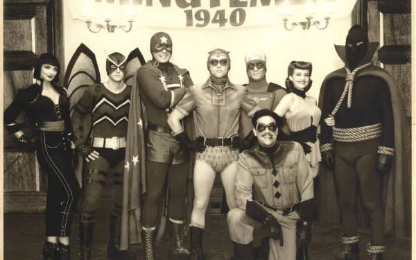 HD PC desktop wallpaper featuring the Watchmen movie cast in vintage 1940s-style superhero costumes, posing together in black and white.
